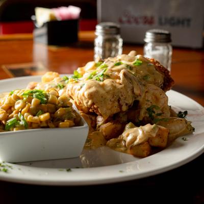 Fried chicken, with creamy Cajun sauce, and corn.