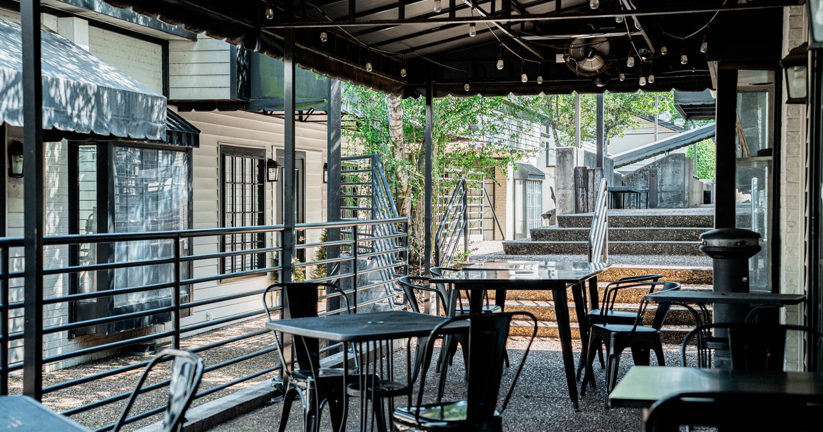 Outdoor café seating with black metal tables and chairs