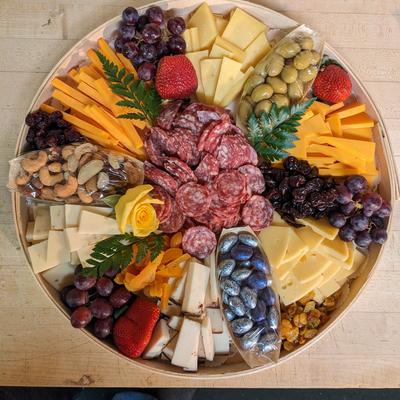 Sausage, cheeses, olives, nuts, and mixed fruits