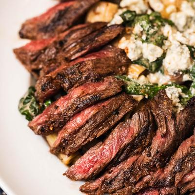 Blackened skirt steak with rigatoni, close up.