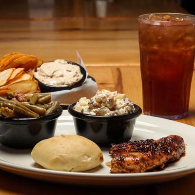 Bourbon Glazed Chicken Breast served with a bread roll, green beans and potato salad.