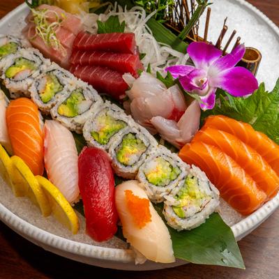 Sushi and Sashimi Combo platter featuring a variety of fish, nigiri, maki rolls and garnishes.