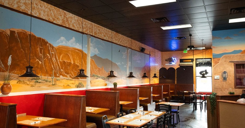 Interior dining space with tables chairs and booths