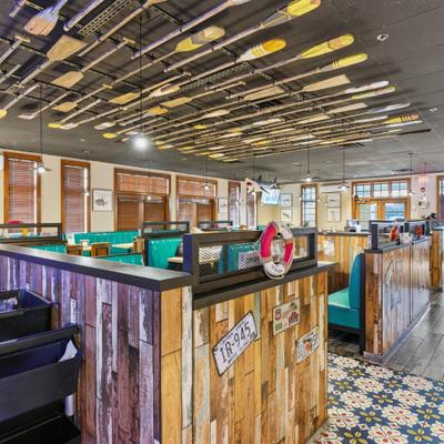 Teal booths and oar covered ceiling design.