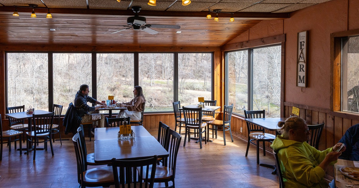 Cozy dining area with several guests seated, eating, and talking