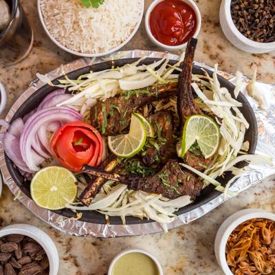 Lamb chops, served with side dishes.