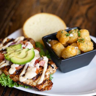 Grilled chicken sandwich and tater tots.