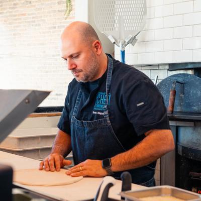 Interior, a pizza maker in action.