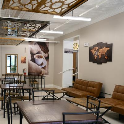 Interior featuring brown leather sofa seating and rustic wood tables.
