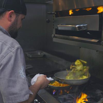 The staff member cooking.