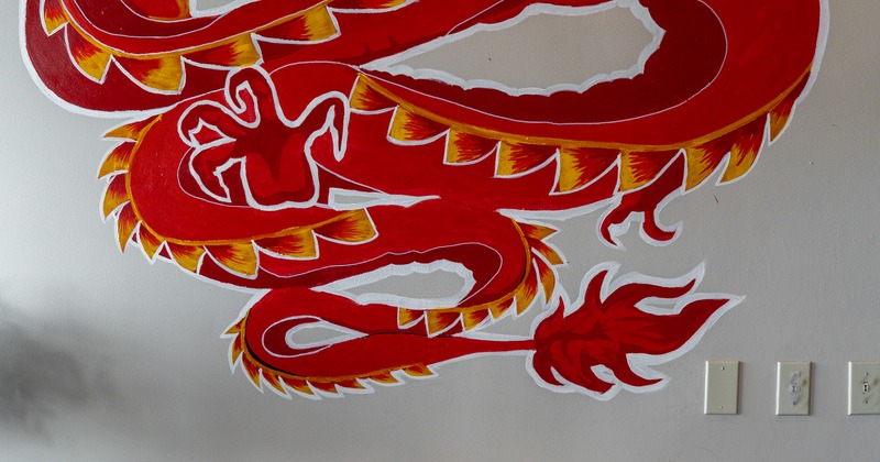 Dragon painted on the wall above booth