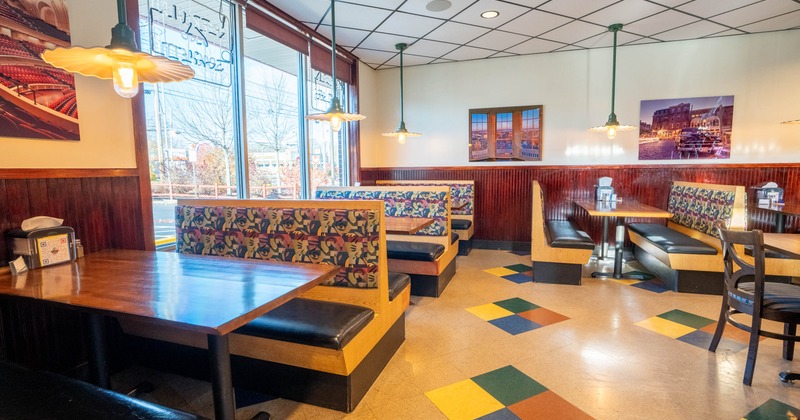 Interior, dining area, seating booths, large shop window with neon signage