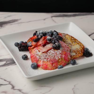 Mexican sweet bread French toast served with fresh fruit and powdered sugar.