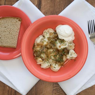 Alaskan beef dumplings served with a slice of bread.