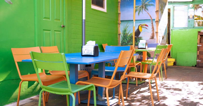 Exterior, seating area, colorful chairs and tables