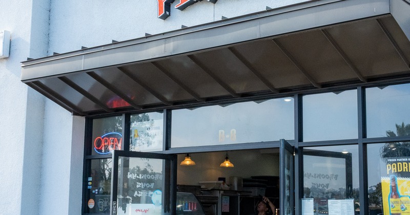 Exterior, entrance to restaurant, sign above