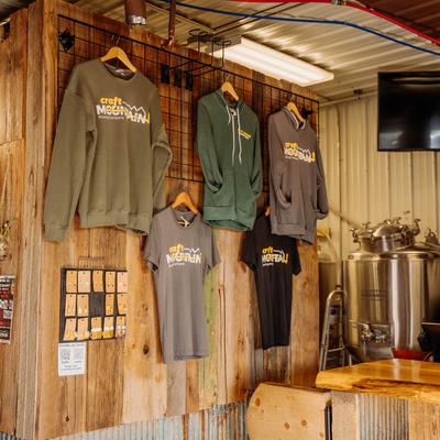 Merchandize displayed on a wooden wall.