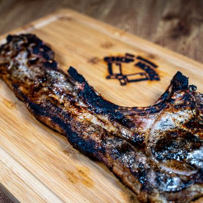 Kan Kan Pork Chop served on a wooden board.