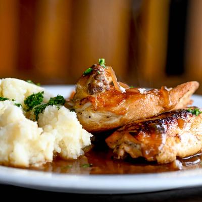 Half-Roasted Chicken, roasted root vegetables, mashed potato, and chicken jus.