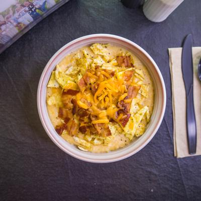 The Army Bowl topped with shredded cheddar cheese and bacon bits.
