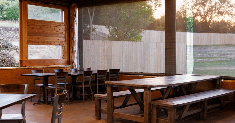 Interior, tables with chairs, long table with wooden bench seating
