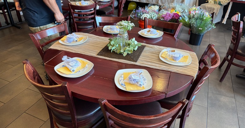 A round dining table elegantly decorated and set for guests