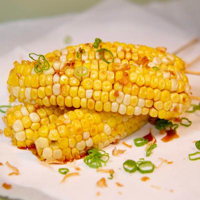 Corn ribs with garlic soy sauce, topped with fried shallots.