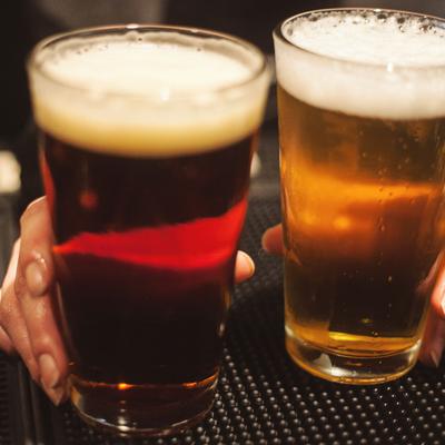 Two glasses of beer served on the counter