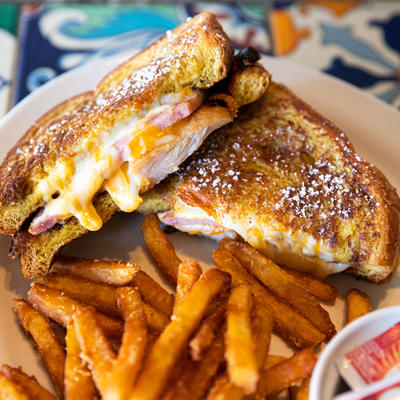 Grilled sandwiches with cheese and bacon, fries on the side