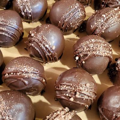 Close-up of several round chocolate truffles.