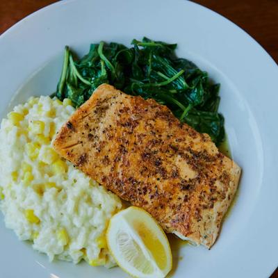 Grilled salmon fillet, with sauteed spinach and corn risotto.