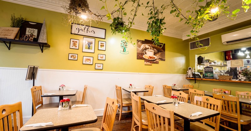 Interior, wooden tables and chairs, framed pictures on the wall