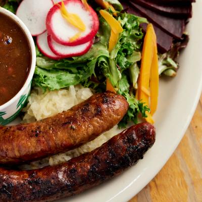 Sausages served with salad and baked beans.