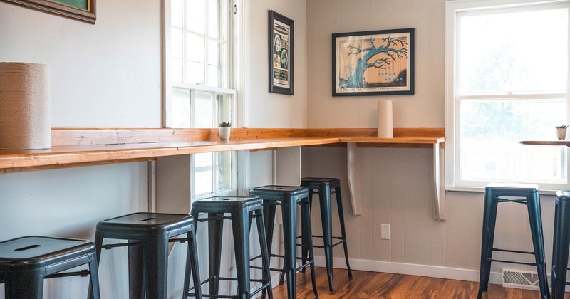 Interior, wooden counter and chairs, pictures on the wall