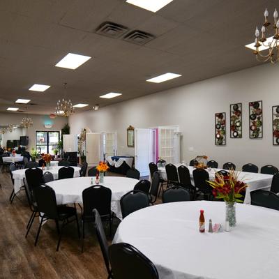 Part of the dining area with tabels and chairs.