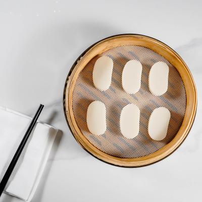 Sweet sticky rice cakes served in a bamboo steamer.