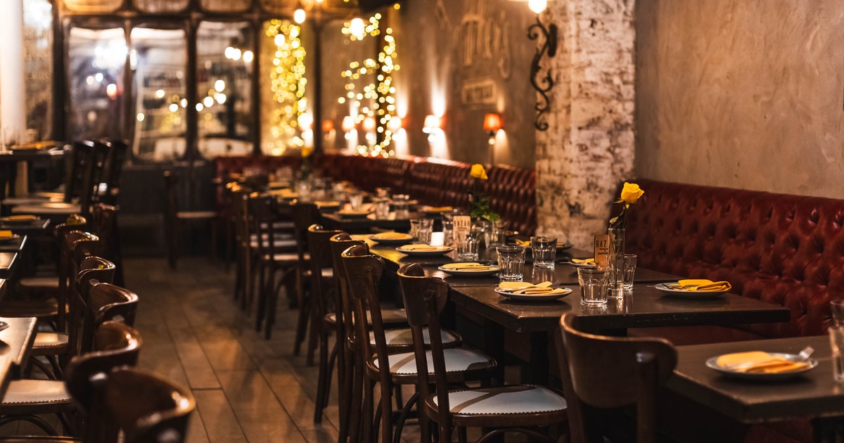 Interior,  dining area, long leather sheeted banquette bench with wooden tables and chairs