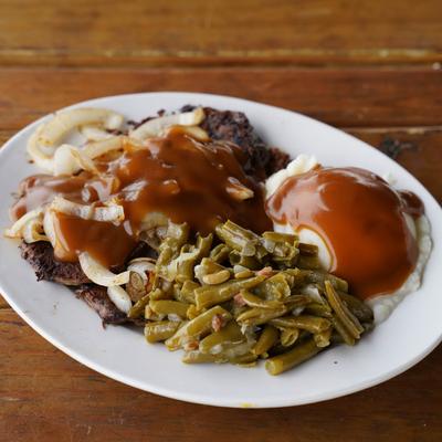 Liver & Onions with brown gravy, mashed potatoes, and green beans.