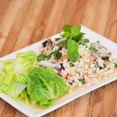 Larb salad with ground meat, onions, cilantro, mint, and roasted rice.