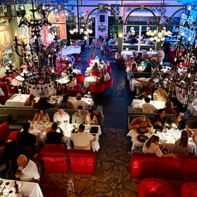 A view of the whole dining room from upstairs. People having dinner at the tables.