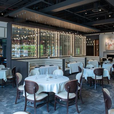 Interior with a mix of table and booth seating and decorative lighting elements.