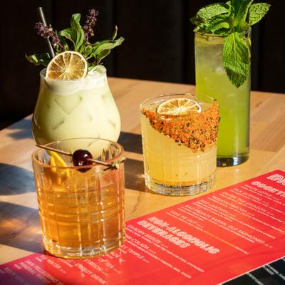 Various cocktails served on the table alongside a menu.
