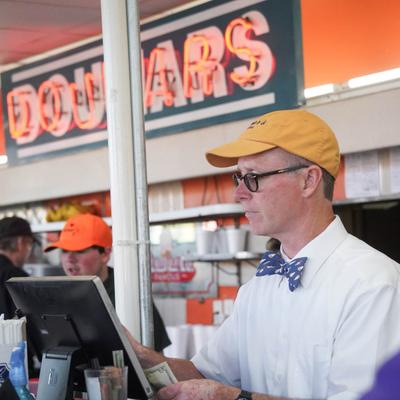 Randy Windley at cash register behind the counter.
