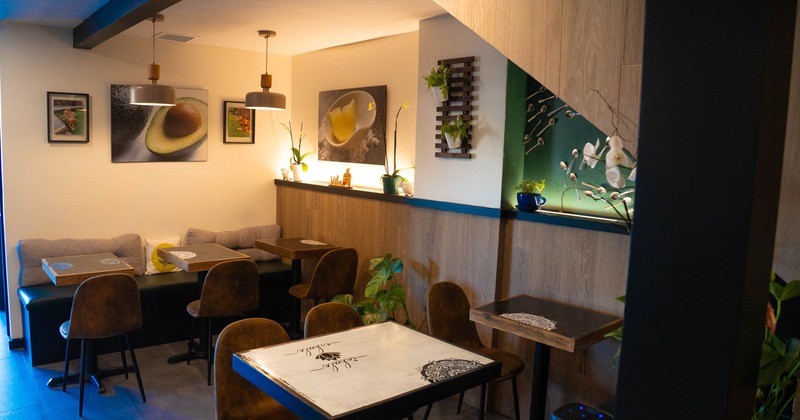 Cozy café corner with tables, chairs, and wall art featuring food images