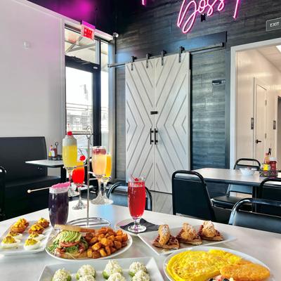 A restaurant table with a variety of delicious food dishes and drinks.