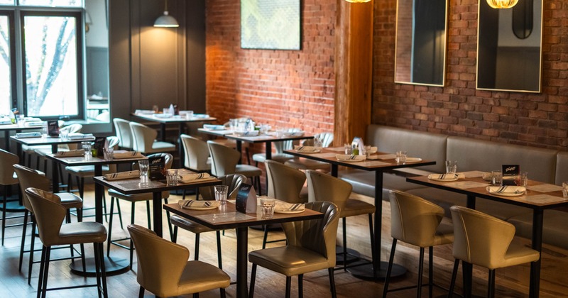 Interior of a modern restaurant, square tables with chairs