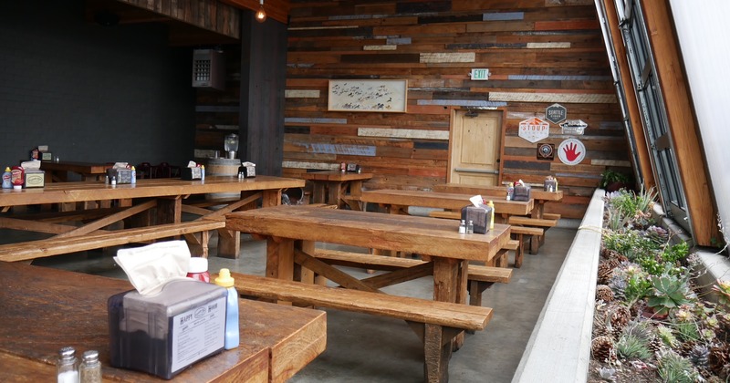 Interior, wooden tables and benches in the seating area