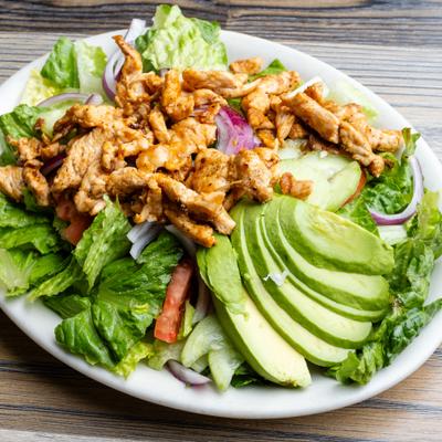 Chicken Avocado Salad with lettuce, tomatoes, cucumbers and onions.