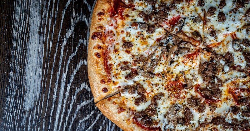 Deluxe Pizza, with sausage, pepperoni, mushrooms, and loads of cheese