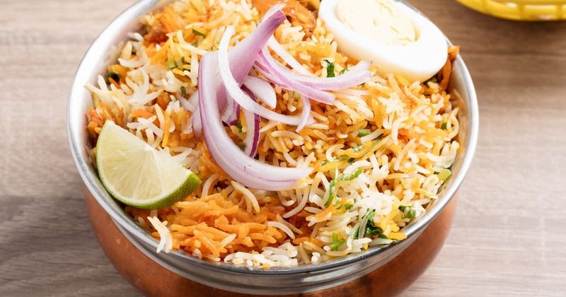 Chicken drum Biryani with fried rice, boiled egg, red onion, and lime